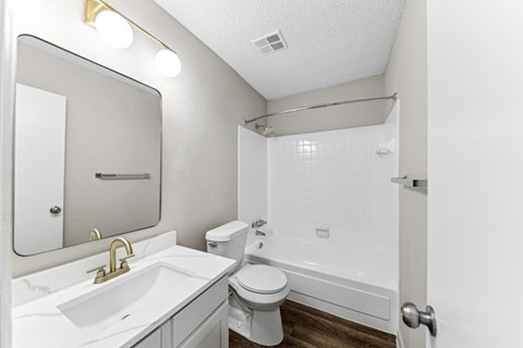a bathroom with a sink toilet and a tub